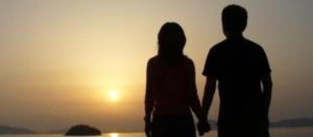A couple holding hand and watching sunset A couple holding hand and watching sunset