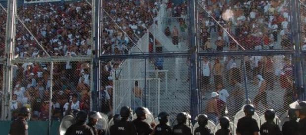 La policía aguantando a radicales durante un juego La policía aguantando a radicales durante un juego