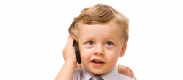 copil cu telefon mobil la ureche copil cu telefon mobil la ureche