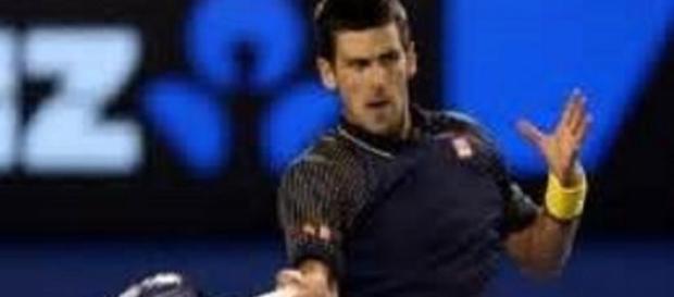 Williams and Djokovic through on day four Williams and Djokovic through on day four