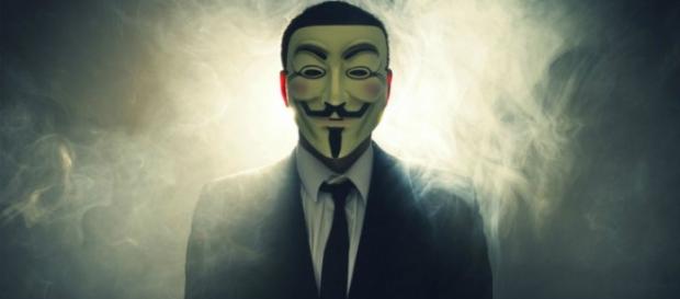 Un membro di Anonymous con la maschera simbolo Un membro di Anonymous con la maschera simbolo