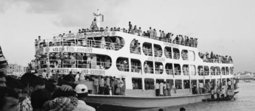 Overcrowded ferry on shores of the Padma River