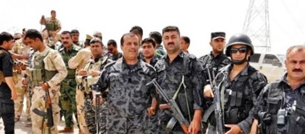 Peshmerga fighters wearing uniforms Peshmerga fighters wearing uniforms