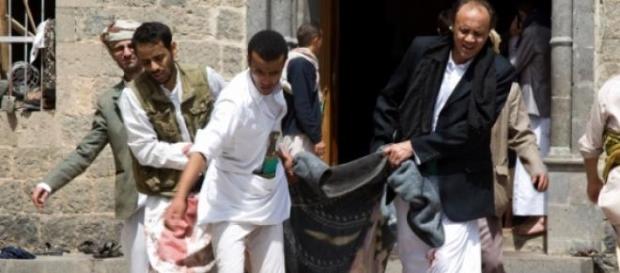 Volunteers carrying the victims in blankets Volunteers carrying the victims in blankets