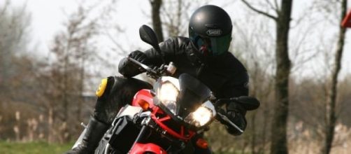 Rider atop an Aprilia sports motorcycle 1000cc