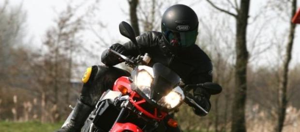 Rider atop an Aprilia sports motorcycle 1000cc Rider atop an Aprilia sports motorcycle 1000cc