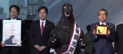 Godzilla receiving his Resident Certificate