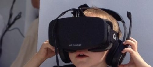 Boy wearing a prototype of Oculus Rift. 