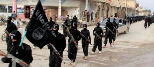 Miliziani dell'Isis con bandiera