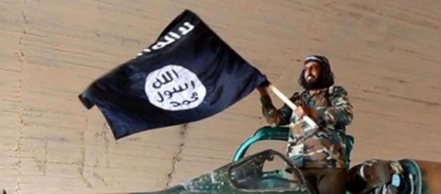 Flag of ISIS and ISIS fighter (Google photo) Flag of ISIS and ISIS fighter (Google photo)