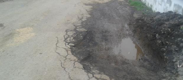 credits, own picture : Pot holes like this are found on most roads in the town credits, own picture : Pot holes like this are found on most roads in the town