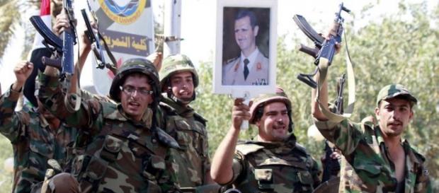 Militari siriani espongono l'immagine di Assad Militari siriani espongono l'immagine di Assad