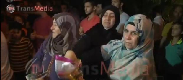 Abu Srour's relatives hand out candies to celebrate his Shaheed status. Screenshot from Israel television news broadcast. Abu Srour's relatives hand out candies to celebrate his Shaheed status. Screenshot from Israel television news broadcast.