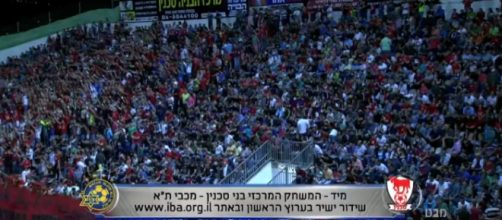 Bleechers full before start of Maccabi Tel Aviv-Sakhnin match. Screenshot: Mabat evening news, Israel public television 25.4.16.
