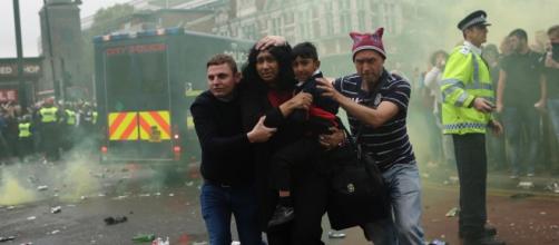 A young family run for cover as West Ham fans riot in the streets (picture by Ed Lodger)