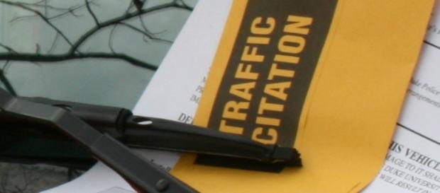 Parking citation on windshield (Wikimedia) Parking citation on windshield (Wikimedia)