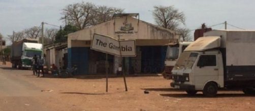 A truck sits for days at The dusty Gambia-Senegal border / Photo via Alhagie Jobe