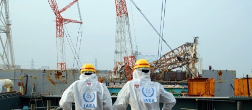 Two IAEA workers at the Fukushima site in 2013 / Photo via Greg Webb, IAEA
