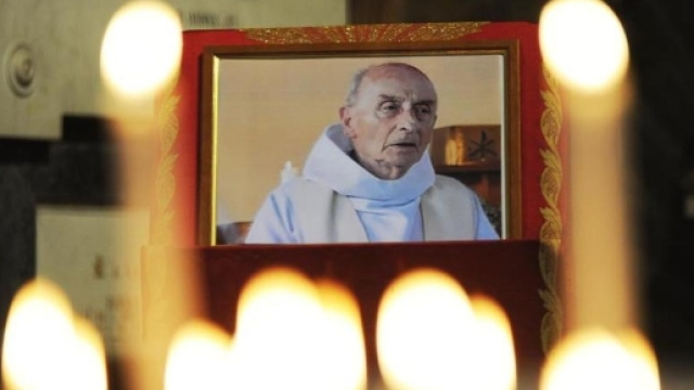 Una piccola foto e tante candele per ricordare padre Jacques Hamel.