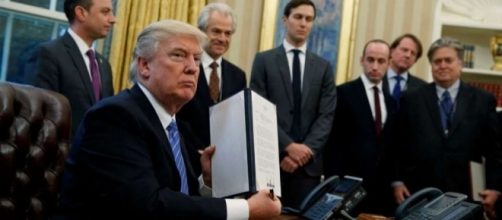 President Trump signing executive orders during first week of presidency. / Photo by Evan Vucci, Blasting News library