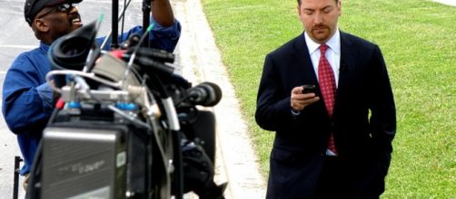 Chuck Todd on phone between broadcasts. Photo by Ray Boone (Flickr Commons)