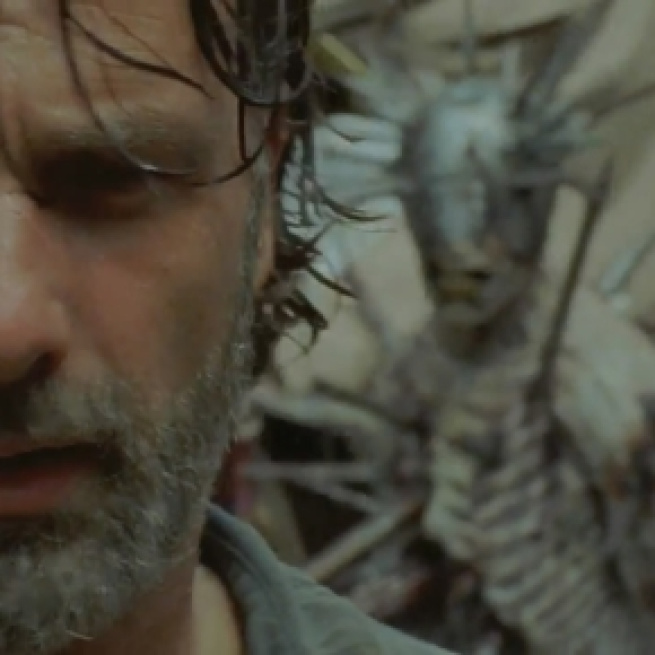 Rick inside the pit at the Junkyard getting ready to fight the spiked walker. Image Credit: AMC