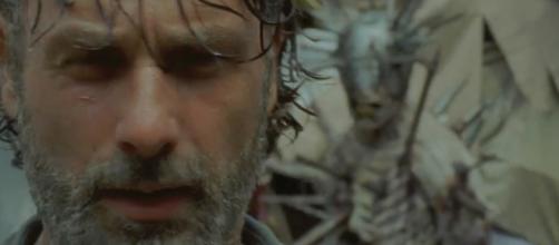 Rick inside the pit at the Junkyard getting ready to fight the spiked walker. Image Credit: AMC