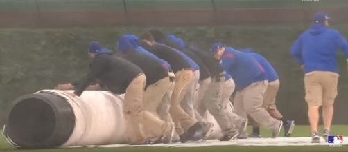 Tarp being rolled onto Wrigley - image - MLB / Youtube