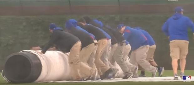 Tarp being rolled onto Wrigley - image - MLB / Youtube Tarp being rolled onto Wrigley - image - MLB / Youtube