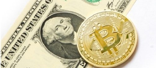 Bitcoin coin and a US dollar [Image Credits:Tombark/Pixabay]