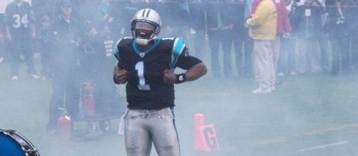 Cam Newton performing his Superman touchdown celebration [Image via Pantherfan11/Wikimedia Commons]