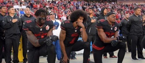 Former 49ers quarterback, Colin Kaepernick, kneels during national anthem in protest... - Image via pbs.org