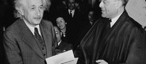 Albert Einstein receiving from Judge Phillip Forman his certificate of American citizenship. [image via Al. Aumuller, Wikimedia Commons]