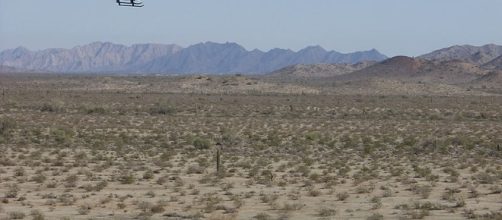 A Border patrol chopper flies over the US-Mexico border in Arizona. [image credit: Dan Sorensen/Wikimedia Commons]