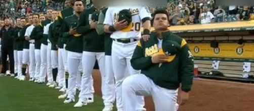 Bruce Maxwell knelt in defiance after Trump's insulting remarks. [Image Credit: 2017 FlashTrendinG/YouTube]
