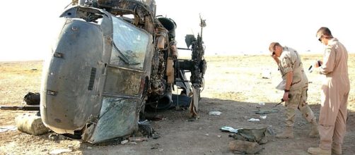 Military safety officials inspect the wreckage of a past helicopter crash in Iraq[image credit;Airman 1st class Jeff Andrejcik/Wikimedia Commons]