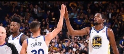 Stephen Curry, Kevin Durant, and the Warriors host the Wizards on Friday night. [Image via NBA/YouTube]