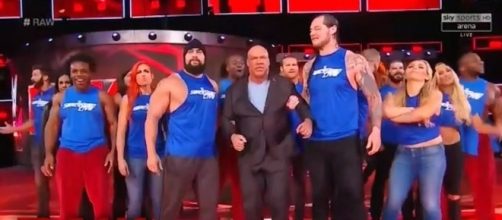 'SmackDown Live' superstars bring 'Raw' General Manager Kurt Angle to the ring after they invaded his show. [Image via WWE/YouTube]