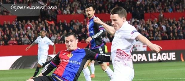 Basel midfielder Taulant Xhaka (Right) tackles Sevilla striker Rami Gameiro in a past match. (Image Credit: Perez-Ventana/Flickr) Basel midfielder Taulant Xhaka (Right) tackles Sevilla striker Rami Gameiro in a past match. (Image Credit: Perez-Ventana/Flickr)
