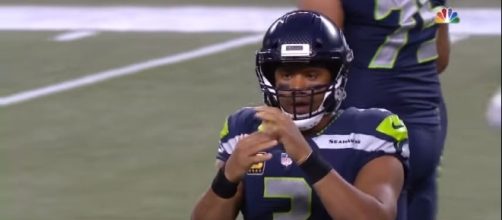 Russell Wilson calling a timeout in a game against the Colts. [Image Credit: NFL/YouTube]