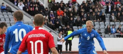Iceland players (in Blue Shirt) in their past match against Denmark.[Image via Flickr Credit: Helgi Halldorson]