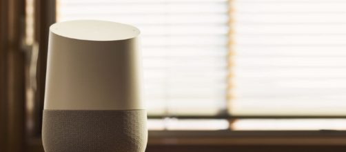 Google Home displayed on a table. (Via Flickr/NDB Photos)