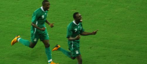 Nigeria soccer players celebrate in a past Olympic competition. (Image Credit: Yang and Yun Album/Flickr)