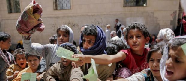 Yemenis present documents in order to receive food rations provided by a local charity, in Yemen's capital, Sanaa. Yemenis present documents in order to receive food rations provided by a local charity, in Yemen's capital, Sanaa.