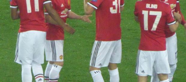 Manchester United players in a past match(Image via Ardfern/Wikimedia Commons) Manchester United players in a past match(Image via Ardfern/Wikimedia Commons)