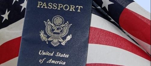 U.S. passport with American flag. (Image via 27707/Pixabay)