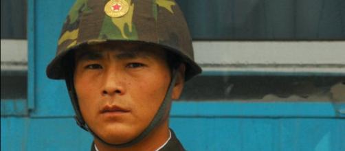 A North Korean Soldier Keeps Face (Image via: Wikimedia Commons).
