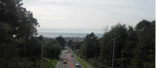 The whole town is seen from the top of a hill.