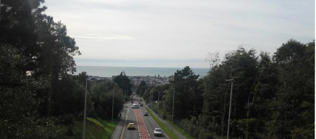 The whole town is seen from the top of a hill. The whole town is seen from the top of a hill.