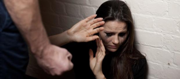 A woman covers her face for protection against a clenched fist - photo posed. Photo Credit: stopdomesticviolence.com A woman covers her face for protection against a clenched fist - photo posed. Photo Credit: stopdomesticviolence.com